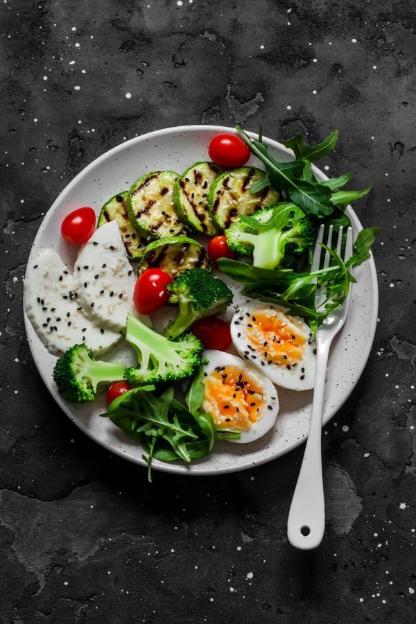 vegetarian-breakfast-snack-bowl-salad-mixed-vegetables-boiled-egg-grilled-zucchini-cheese-dark-background-top-view